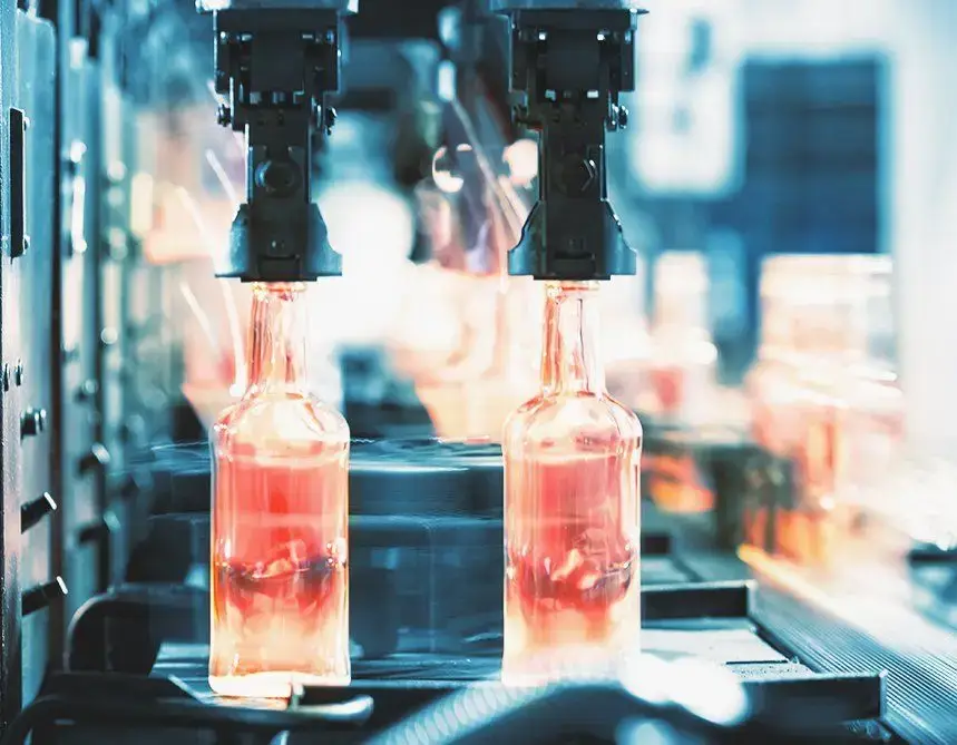 Hot glass bottles on the factory conveyor
